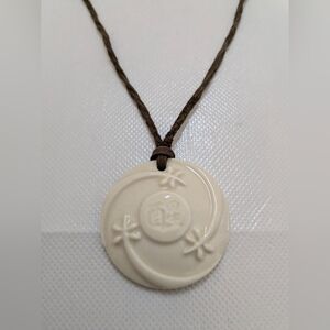 Cream Round Hawaiian Floral Pendant Necklace on Brown Cord
